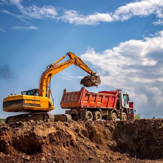Excavator loading a tipper truck during bulk earthworks